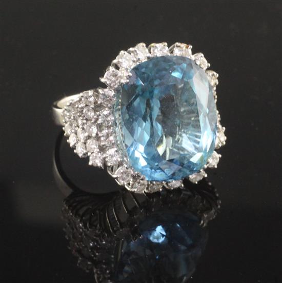 A modern 18ct white gold, blue topaz and diamond set dress ring, size U.